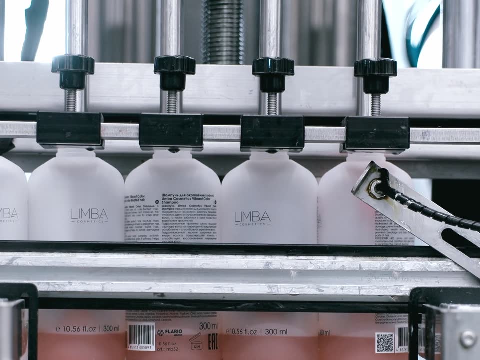 Limba Cosmetics bottles on an automatic filling line